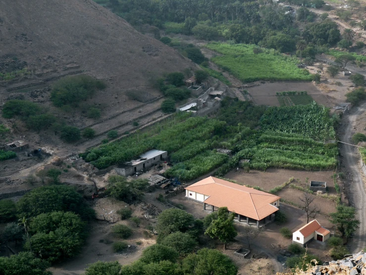 a farm with lots of green grass and mountains