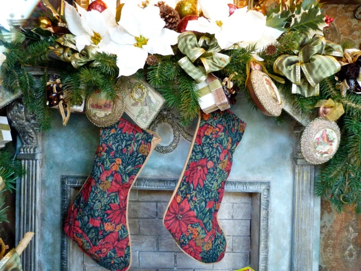 a decorated fireplace mantle next to wreaths, stockings and christmas decorations