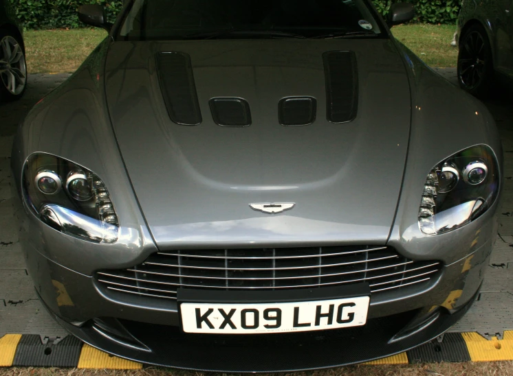 an image of a silver car parked near the curb