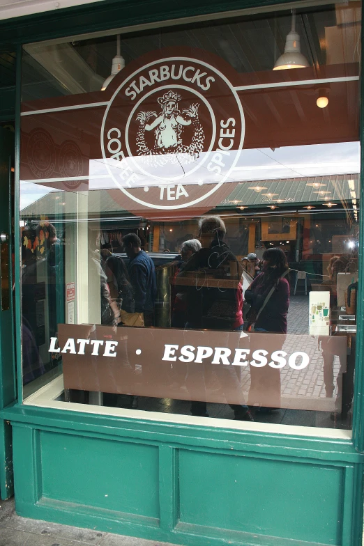 two people looking through the window of a shop