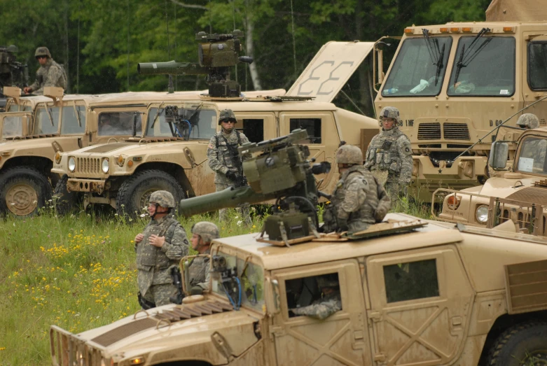 military vehicles lined up in a grassy field