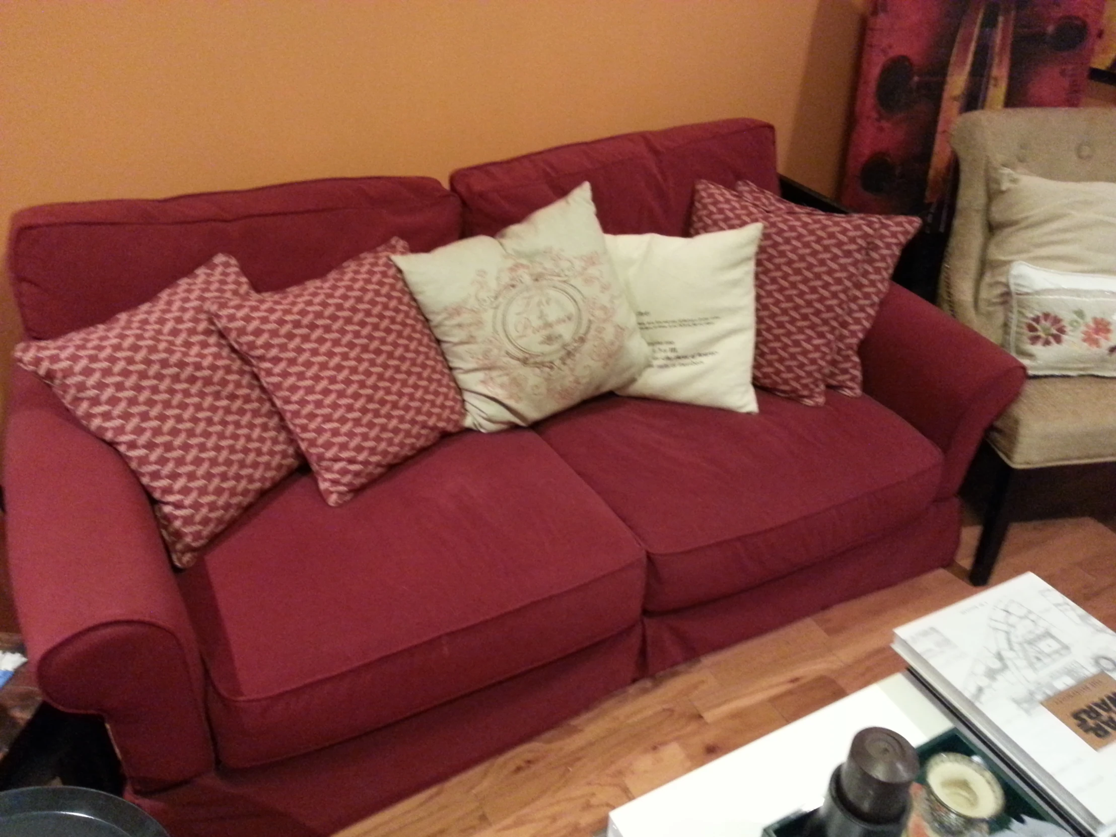 the sofa in the living room has many pillows on it