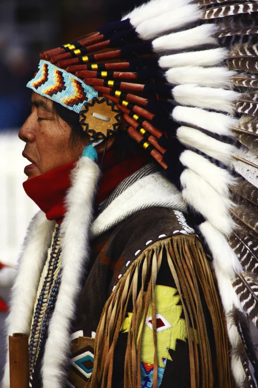 native indian man with feather headdress and red scarf