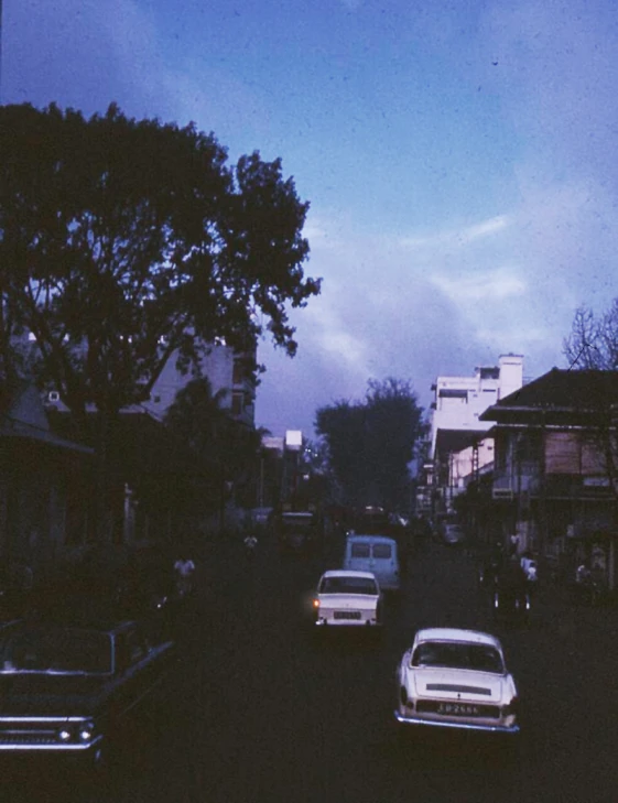 an evening view looking down a street at cars