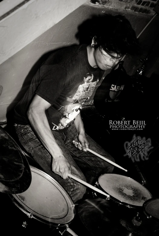 a black and white po of a man playing drums