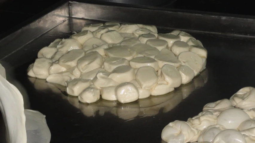 some pieces of bread that is being cooked on a grill