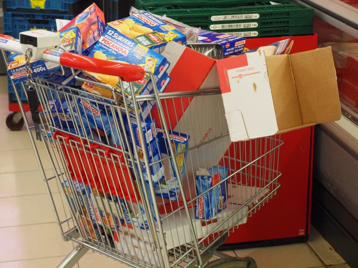 a grocery cart filled with groceries next to other boxes