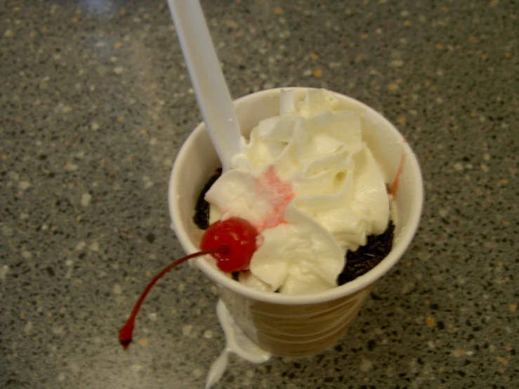 an ice cream and chocolate drink in a cup with a spoon