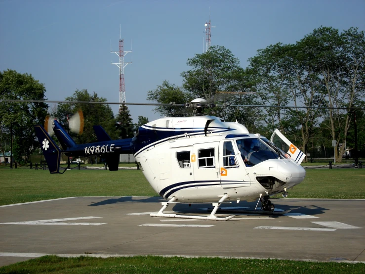 a helicopter is parked on a tarmac at an airport