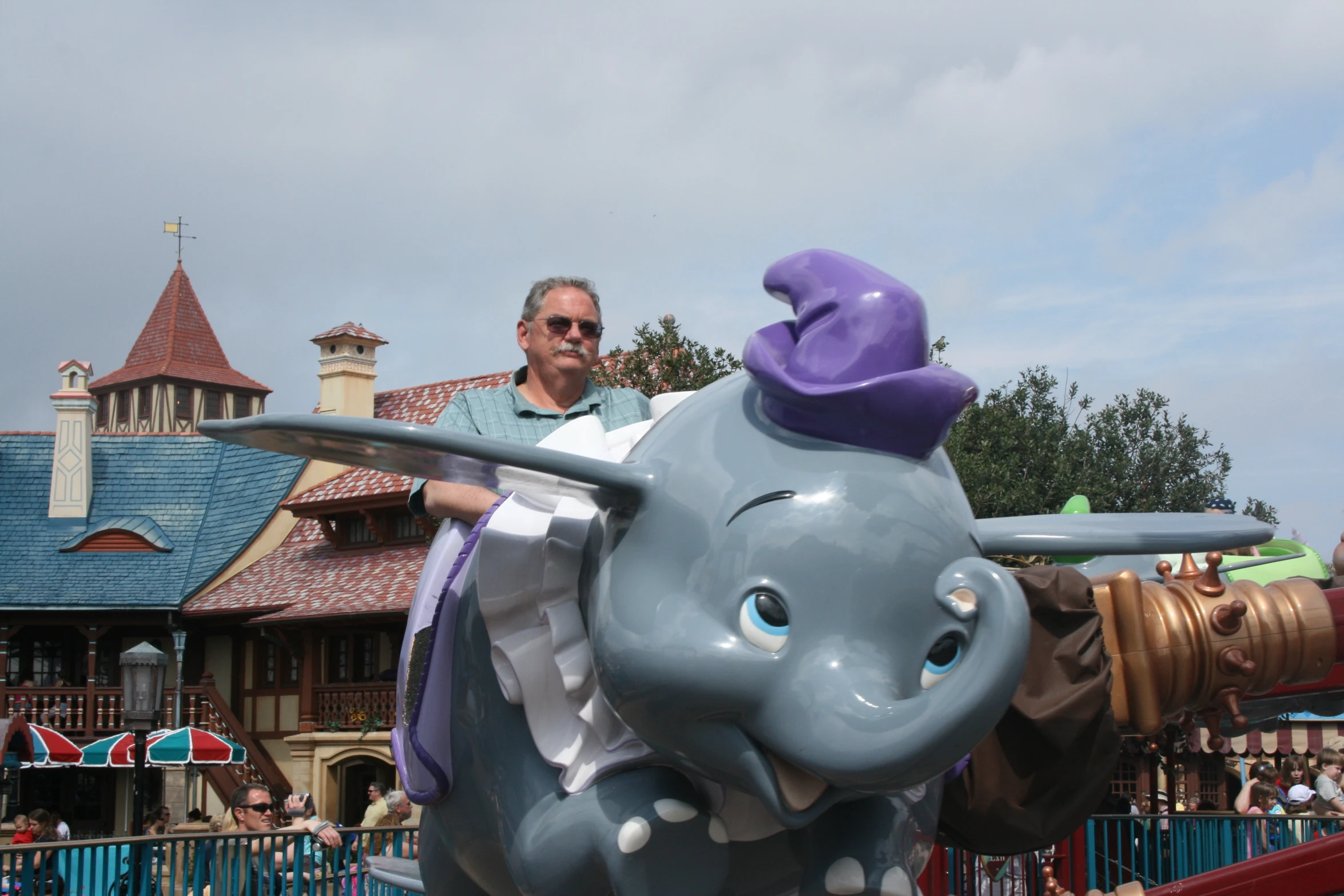 a man standing next to an elephant statue