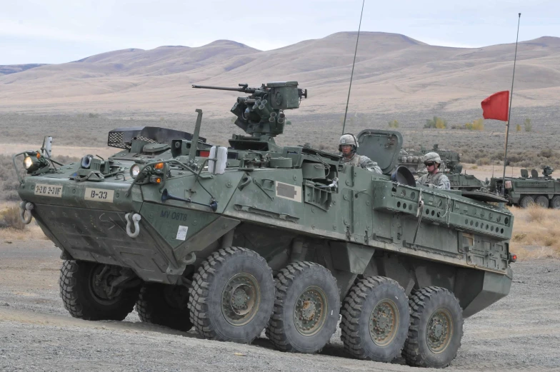 military vehicles moving on the dusty road during the day