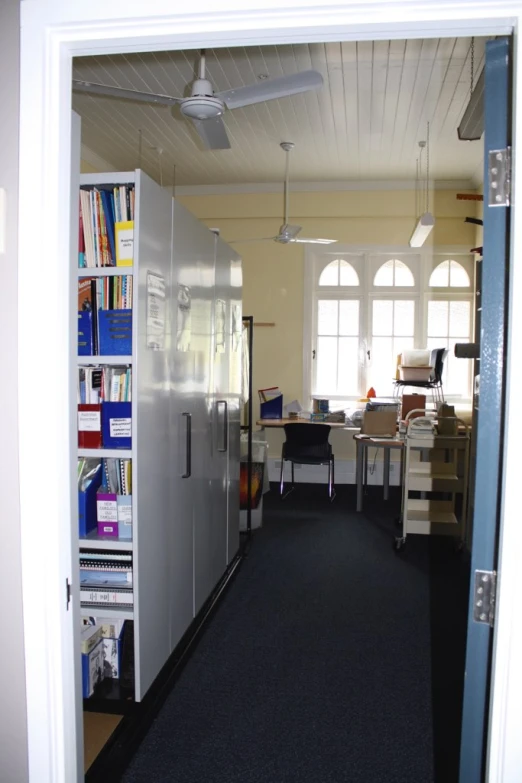 an open door shows the inside of a kitchen and living area