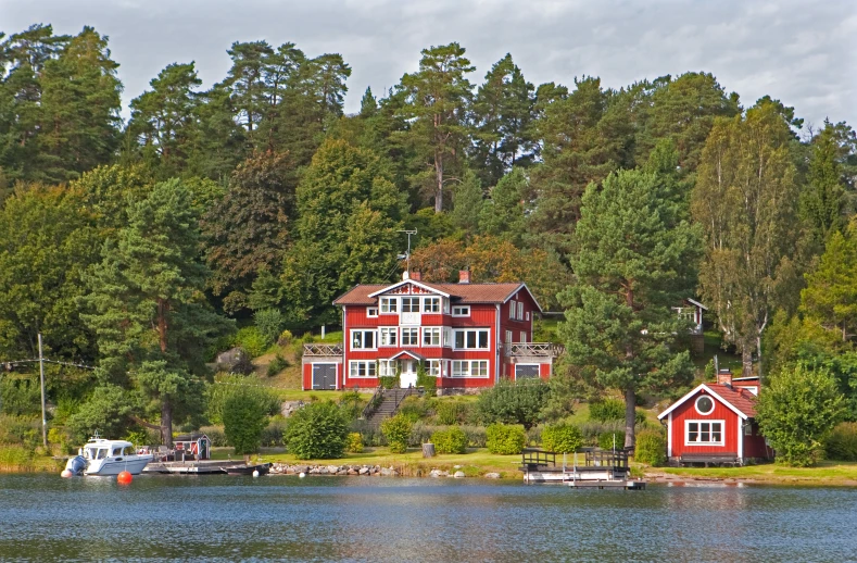 some houses sitting next to a body of water