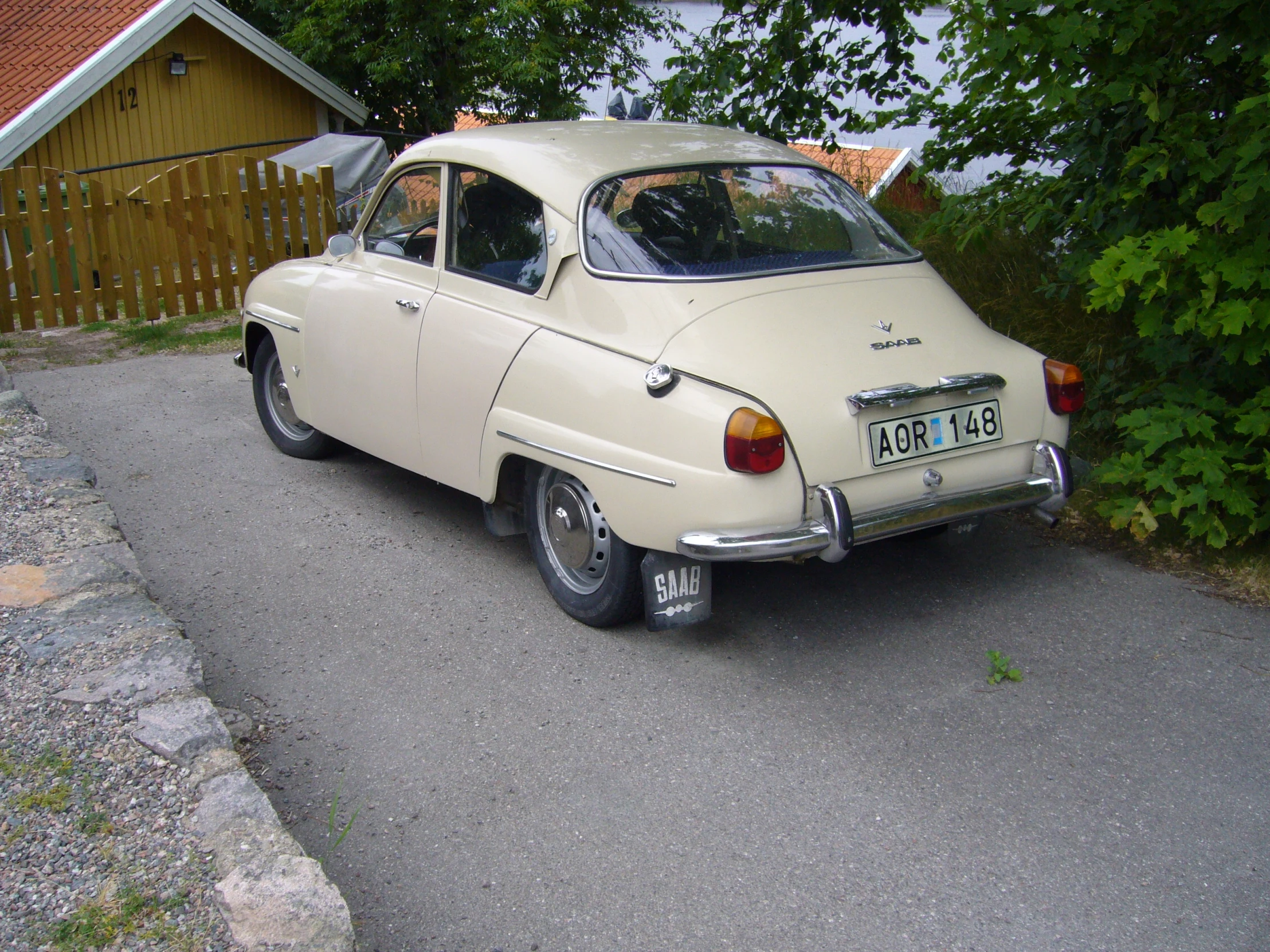 a car is parked on the curb next to a house