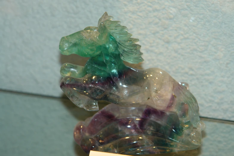 a closeup of some glass animals in front of a wall