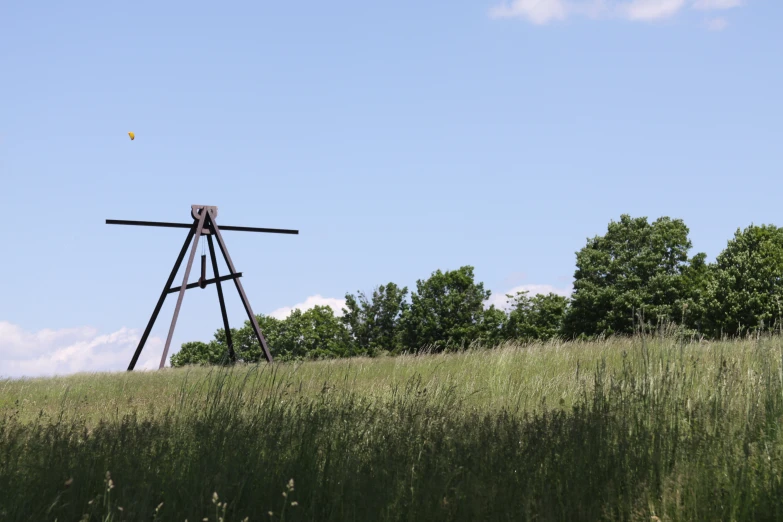 the windmill has an observation tower in the middle of a field