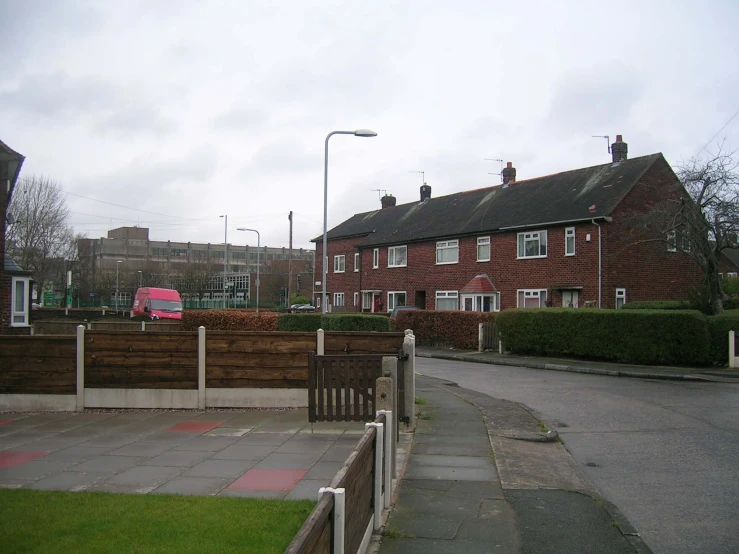 this is a long, empty street lined with red brick houses