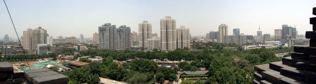 buildings with very tall towers and trees all around