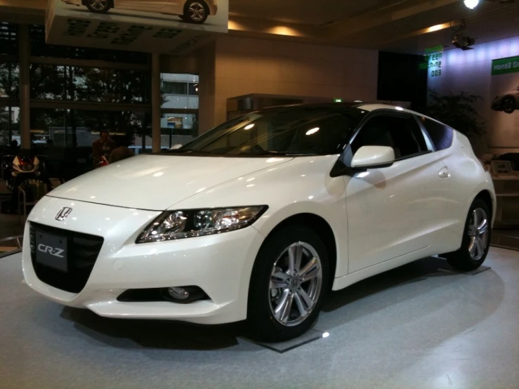 the white car is on display at the show