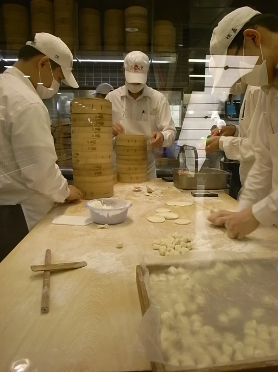 the men in the kitchen are mixing together ingredients