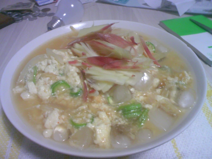 a white bowl of food on top of a table