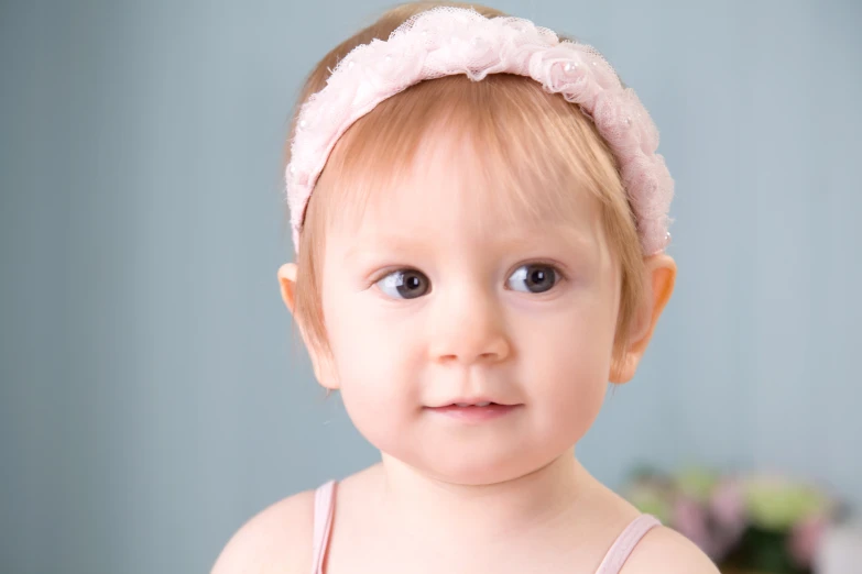 a very pretty little girl wearing a pink dress