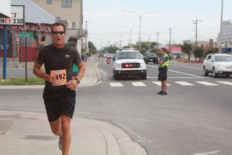 a man running in the street with a person behind him