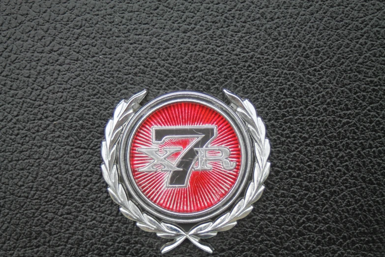 the emblem on the floor of a black leather vehicle