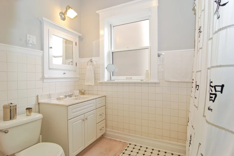 a bathroom with a sink, mirror, and toilet