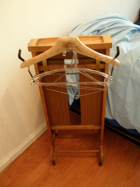 a clothes rack is holding clothes while laying on the floor