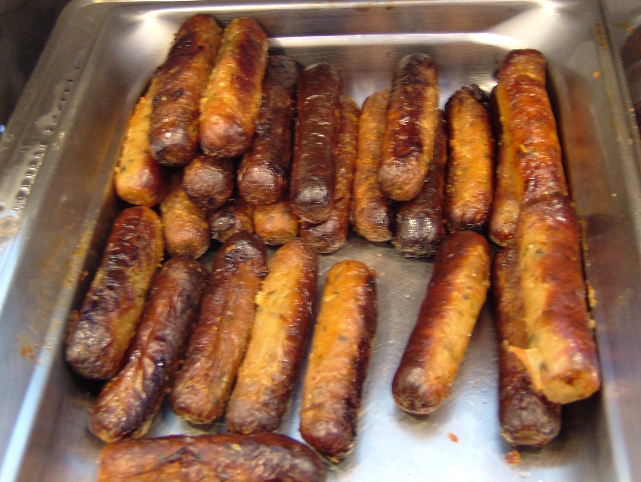 a pan filled with sausages and a bunch of  dogs