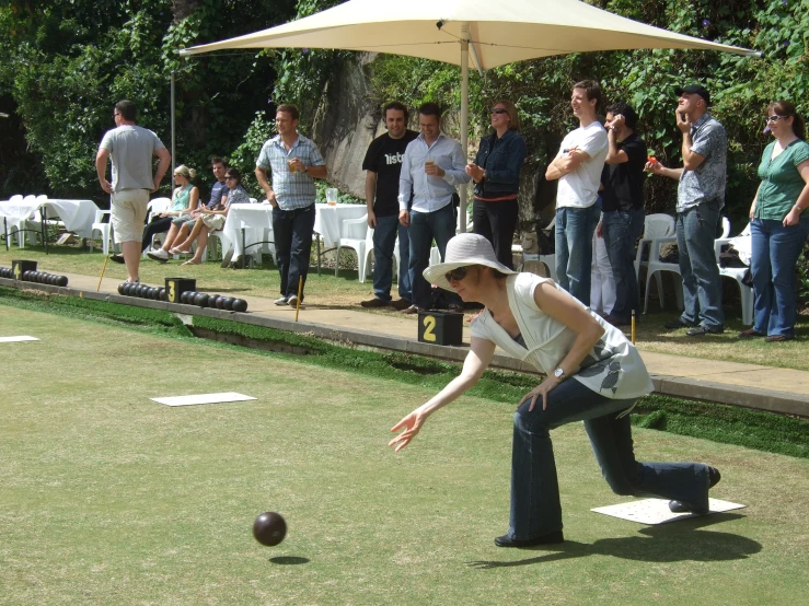 people watching as a woman catches a ball