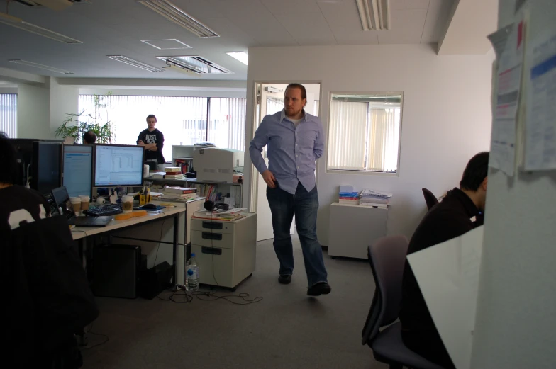 two guys looking at computers in an office