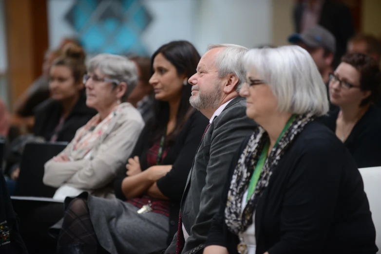 several people sitting in a line at a convention