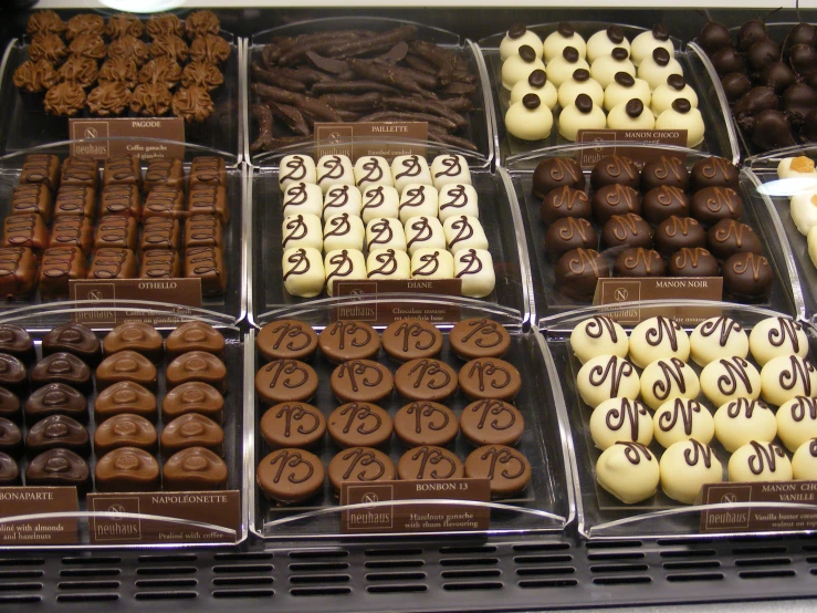 many different types of pastries sitting on display