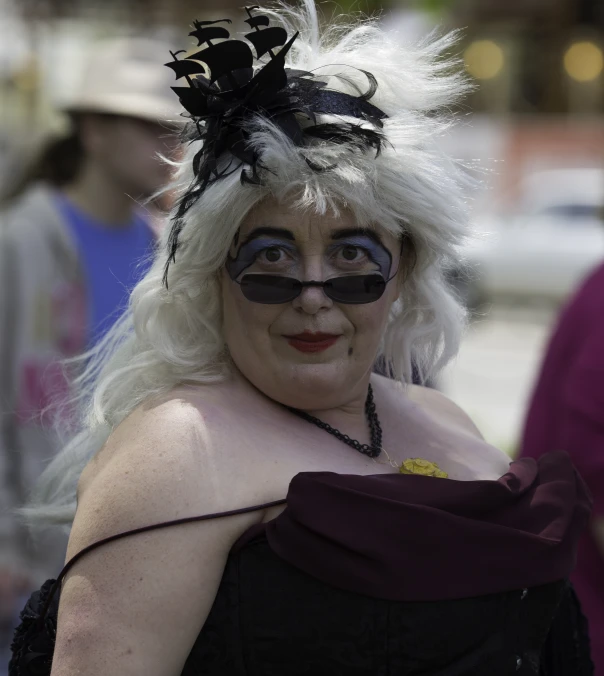 a woman with big  and long hair, wearing white makeup