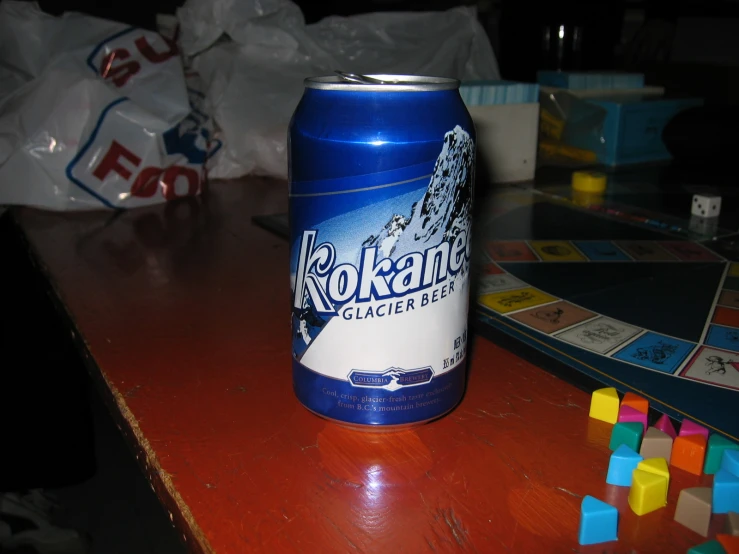 a can of okkohn is next to a board game