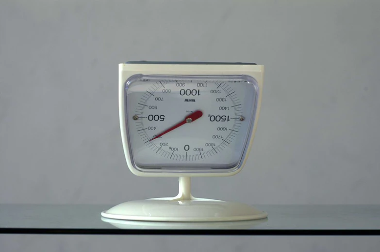 there is a thermometer sitting on a pedestal