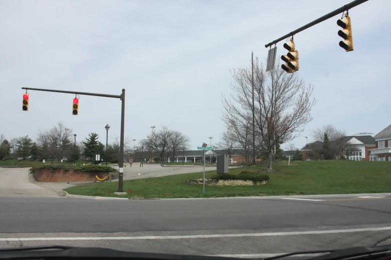 two traffic lights at an intersection in the suburbs