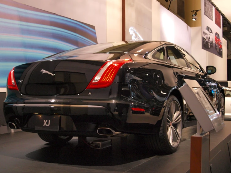 the side view of a black mercedes s - class at a car show