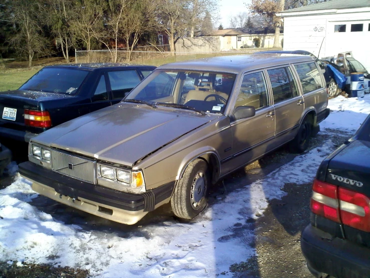 a silver station wagon parked on a snowy parking lot