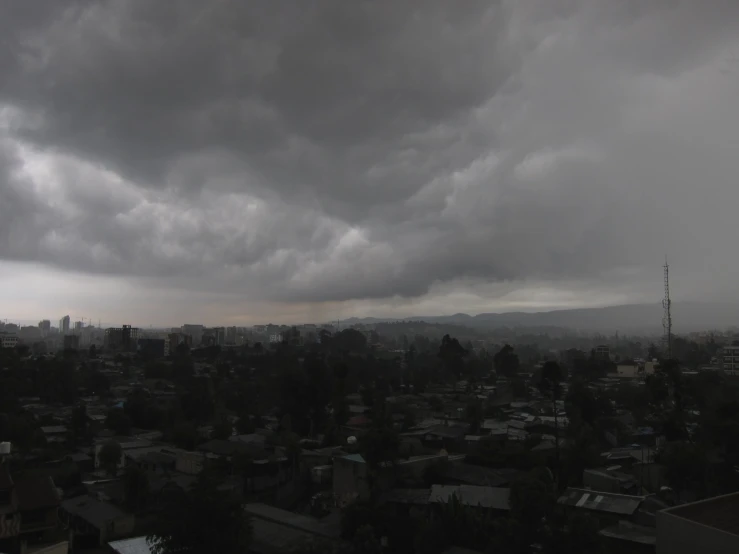 rain and dark clouds fill the sky above a city