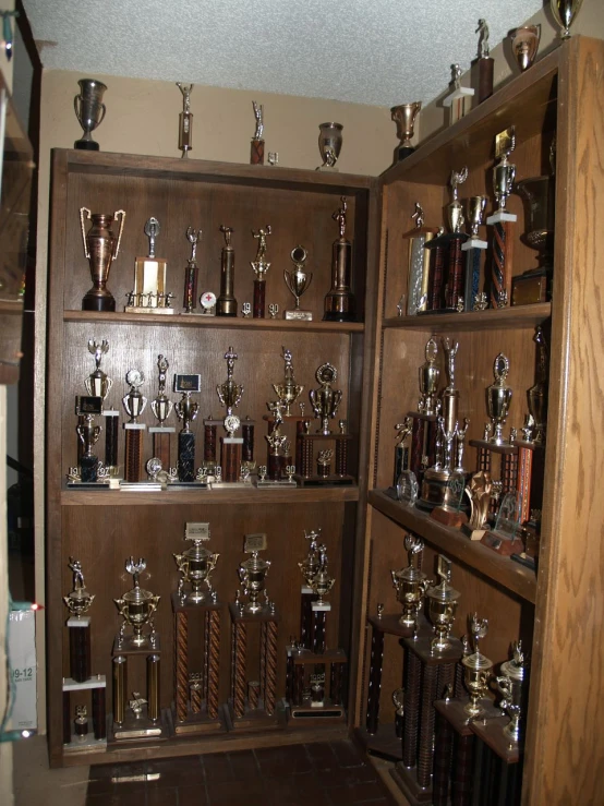 a display case filled with trophy cups and trophies