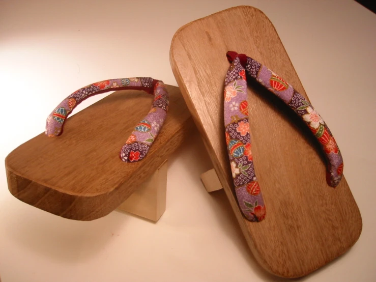 a wooden pair of shoes are laying on top of a table