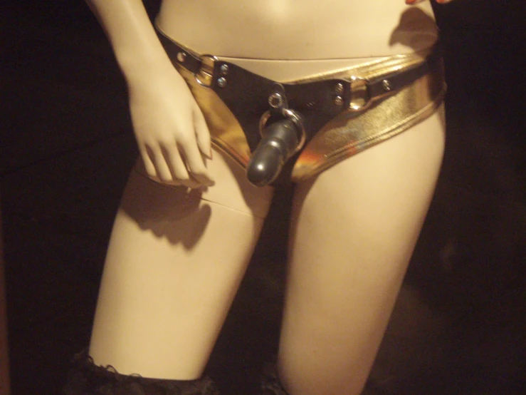 a mannequin wearing a belt with two bells attached to it