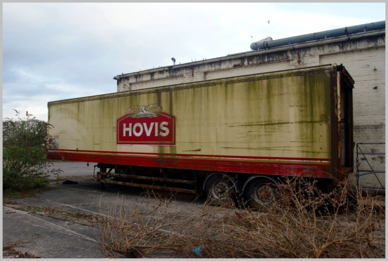 an old, yellow and red truck with a hovis sticker
