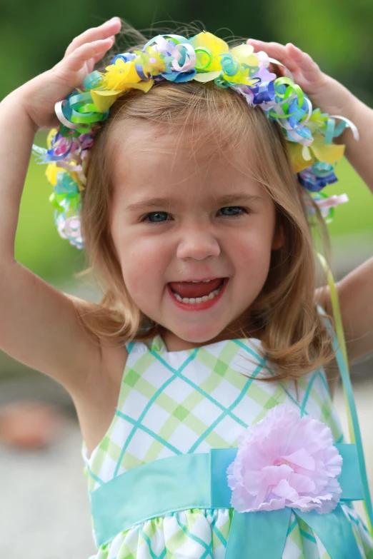 a girl in a dress with a wreath around her head