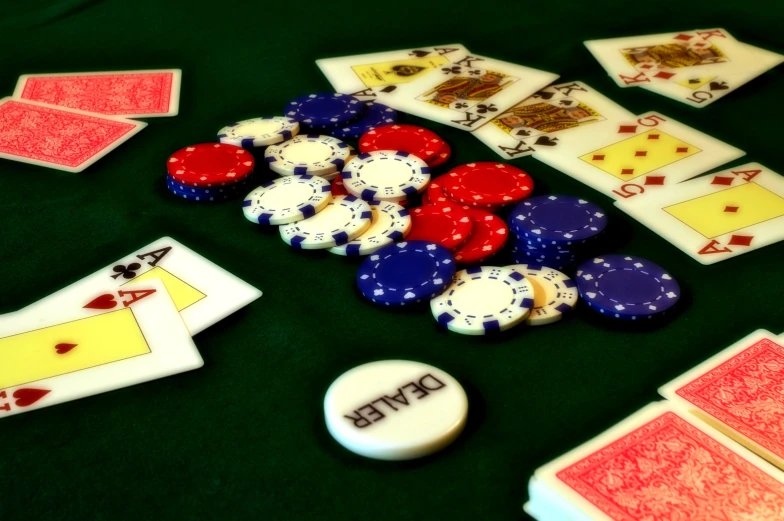 four poker chips and playing cards are set out