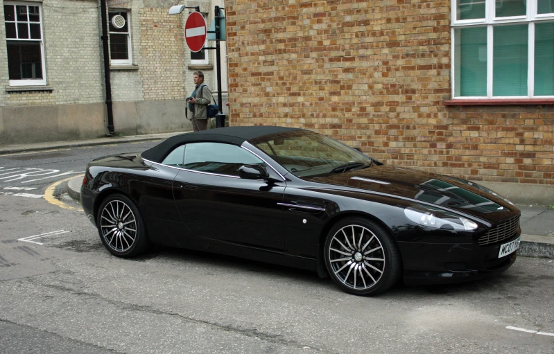 a luxury sports car parked in front of a building