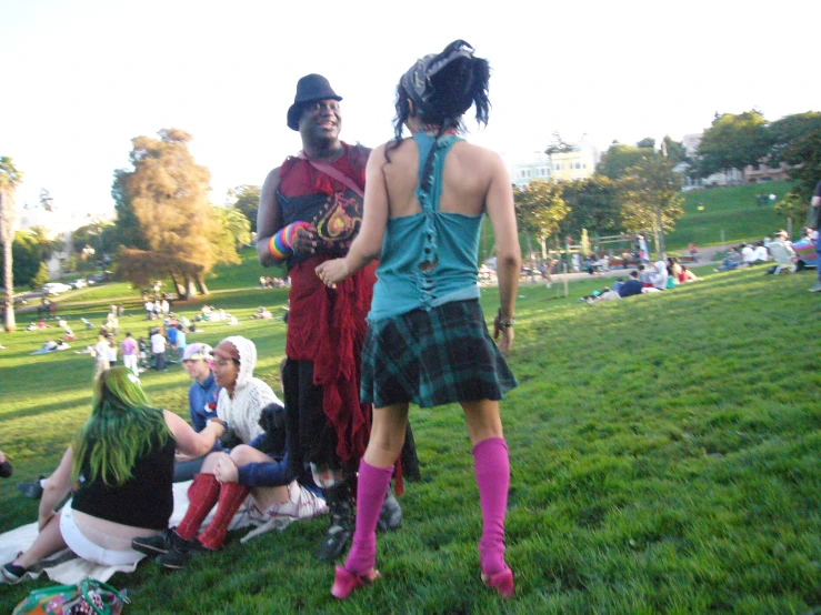 two women standing with other people in the park